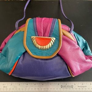 Colorful and bright genuine leather handbag. Hinge closure.